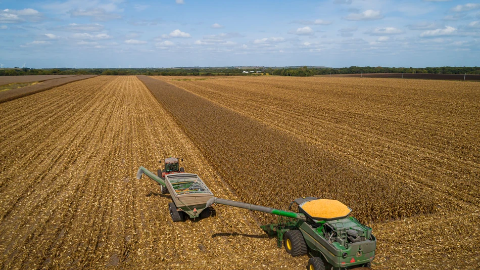 farming field with trackers harvesting crops