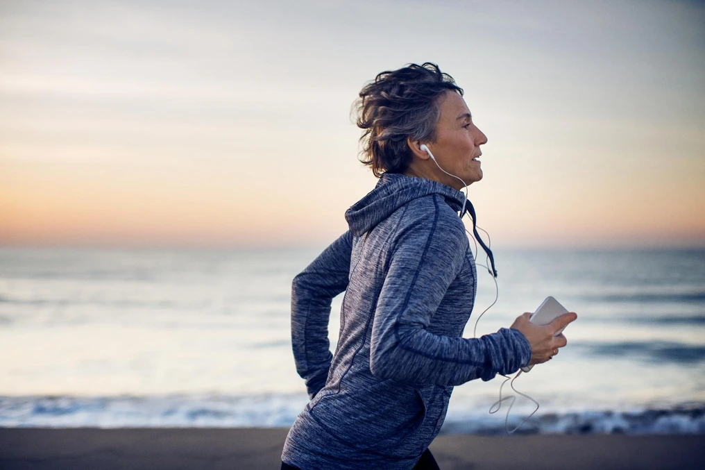 Woman running by the sea