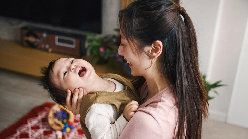 Mother and son embracing and smiling