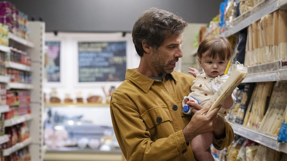 Father and daughter shopping for pasta in the supermarket