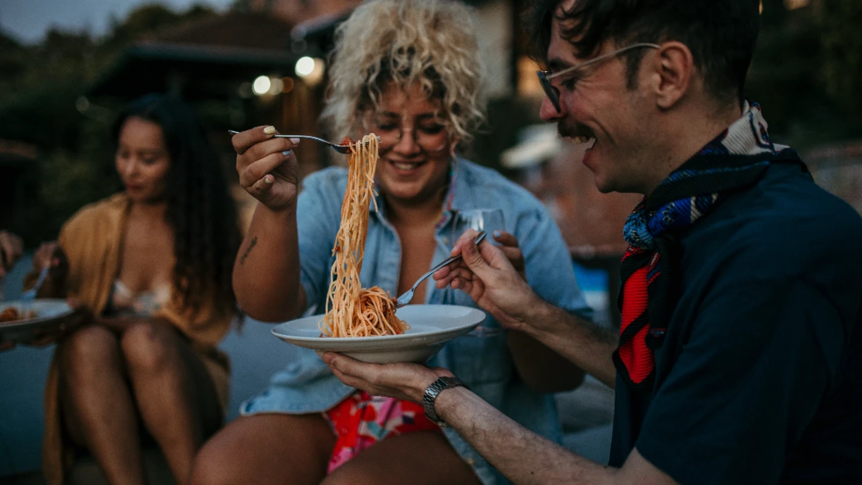 Friends eating pasta