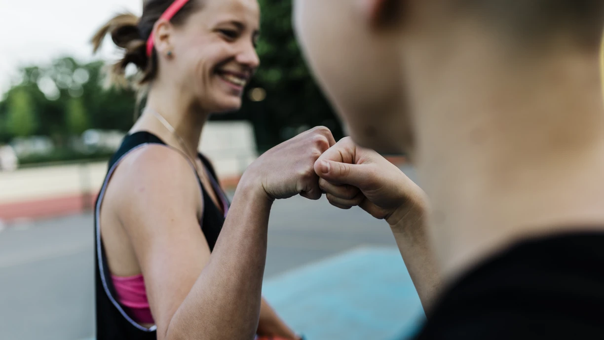 Women Basketball players greeting each other with a fist bump 