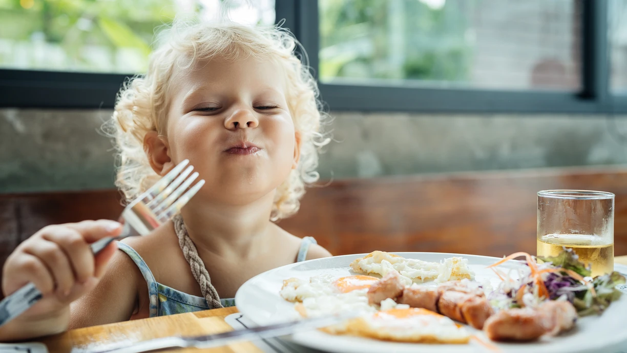 Child eating and smiling