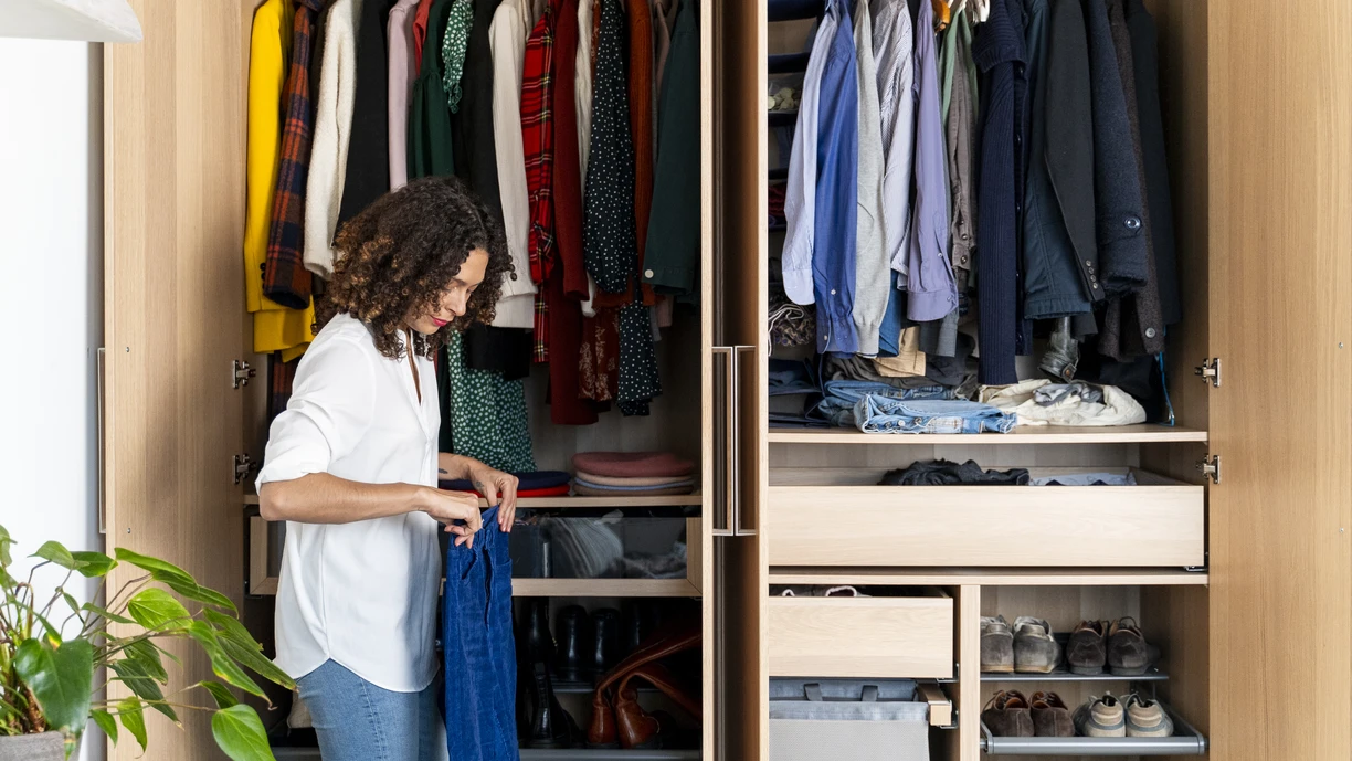 woman putting clothes away