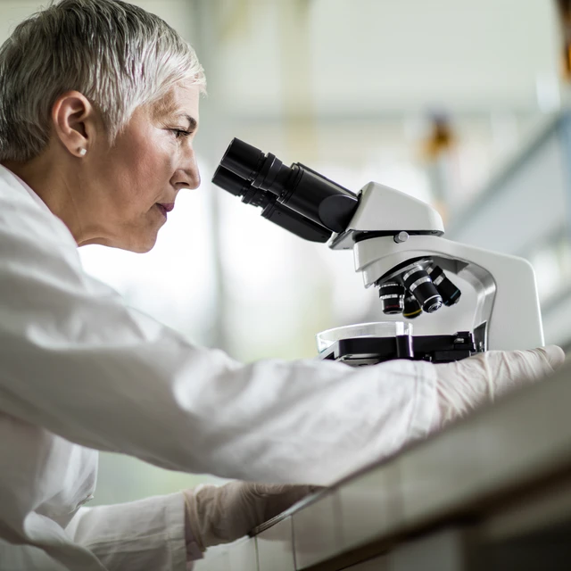 Scientist looking through microscope
