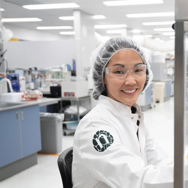 Lab-girl-smiling-to-camera-in-Novonesis-coat