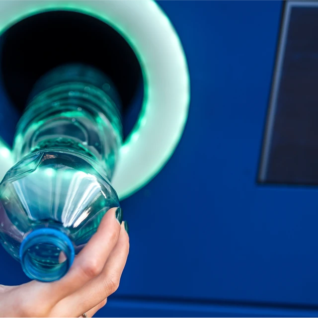 Woman hand recycling plastic bottles