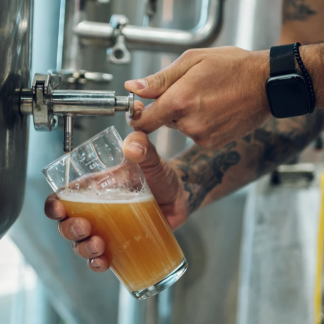 Brewer pouring beer