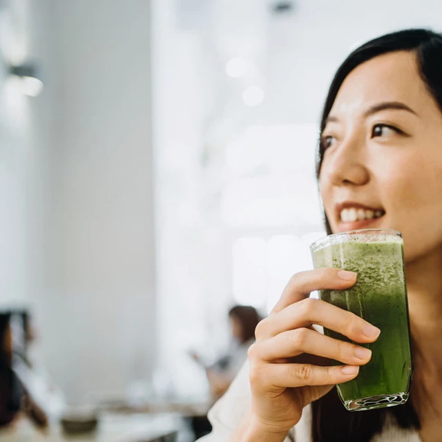 Woman drinking a healthy vegetable juice