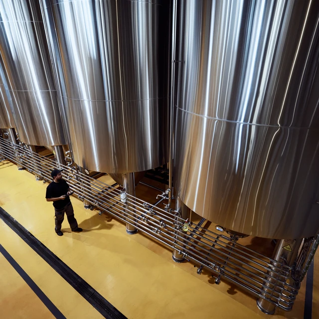 Fermentation tanks seen from above with worker below