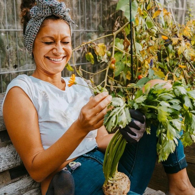 woman looking at flower