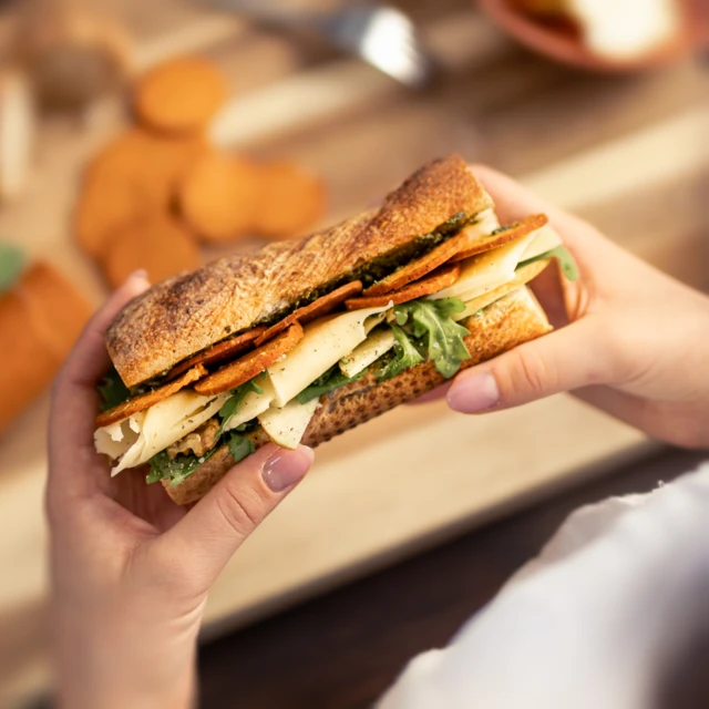 Plant-based salami in a baguette sandwich with cheese and rocket 