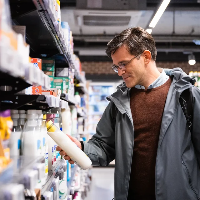 man buying fabric softener in the supermarket
