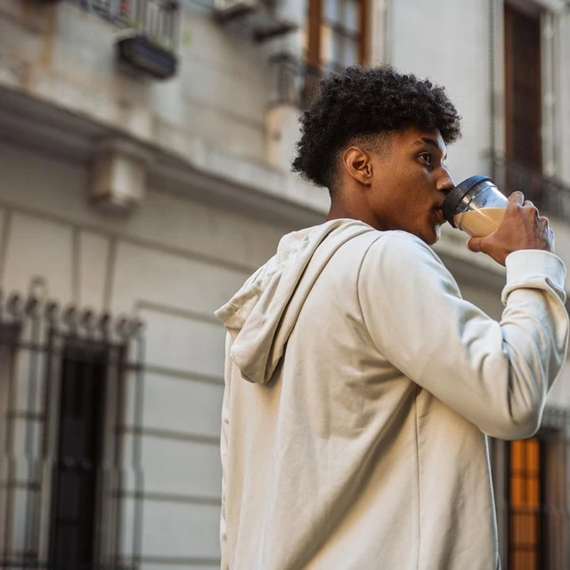man drinking plantbased latte