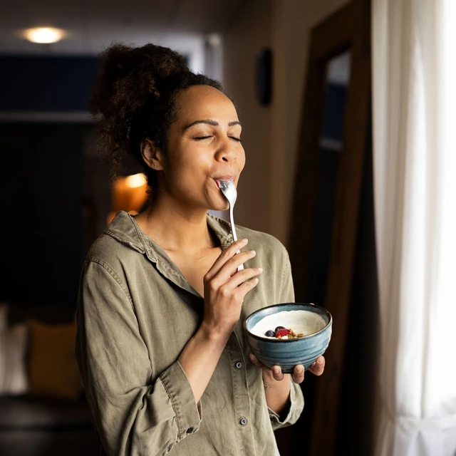 woman-enjoying-yoghurt-eyes-closed-novonesis