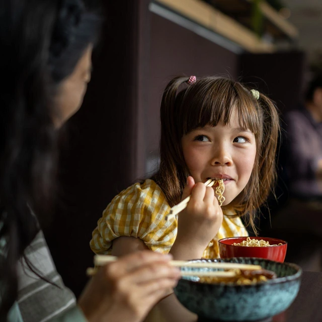 girl-eating-noodles-with-chopsticks-002-novonesis