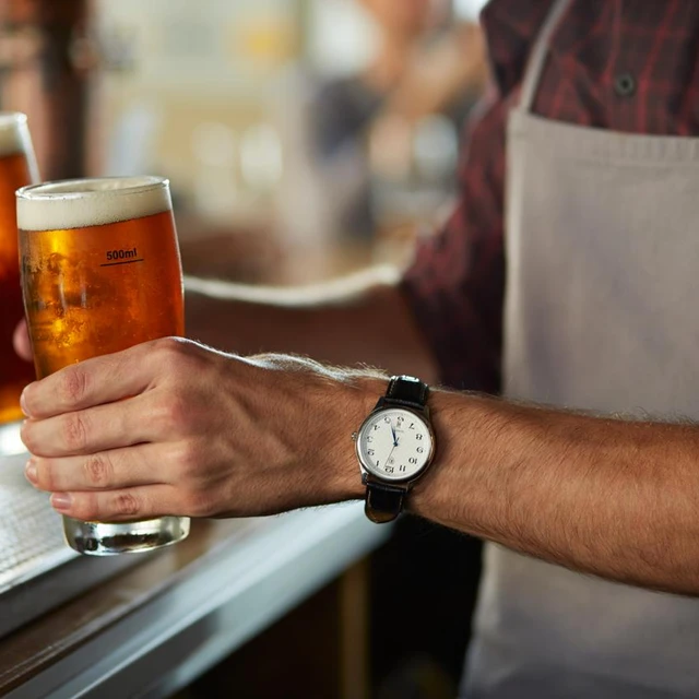 Bar person with pints of beer