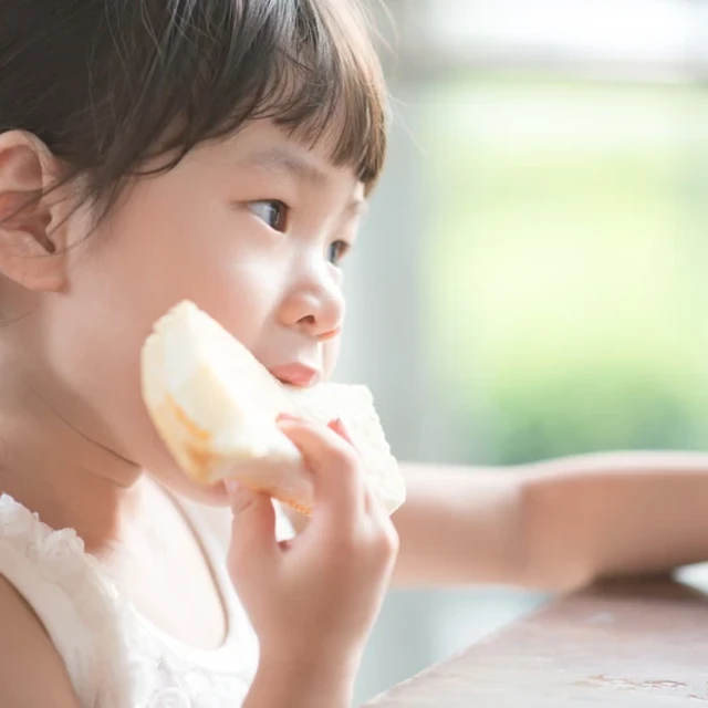 Girl eating bread