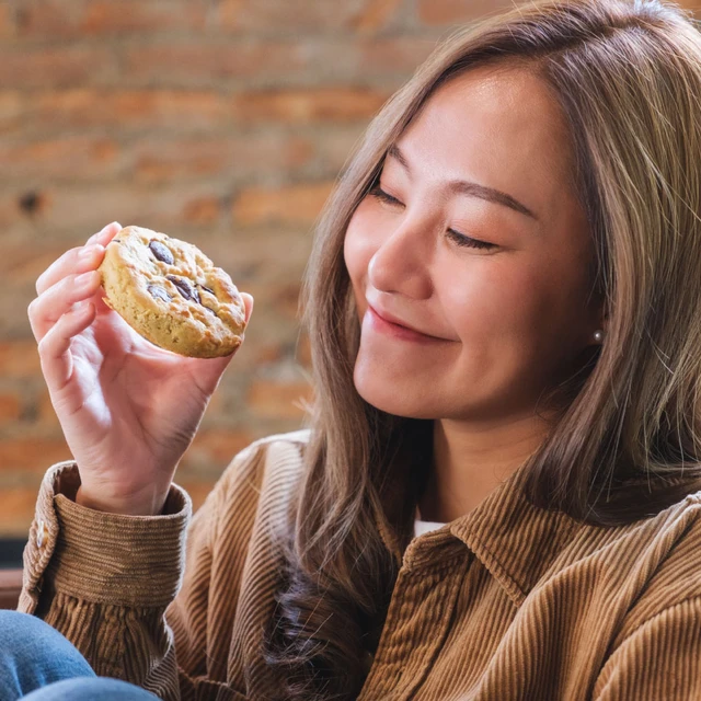 Woman eating a Rostar biscuit