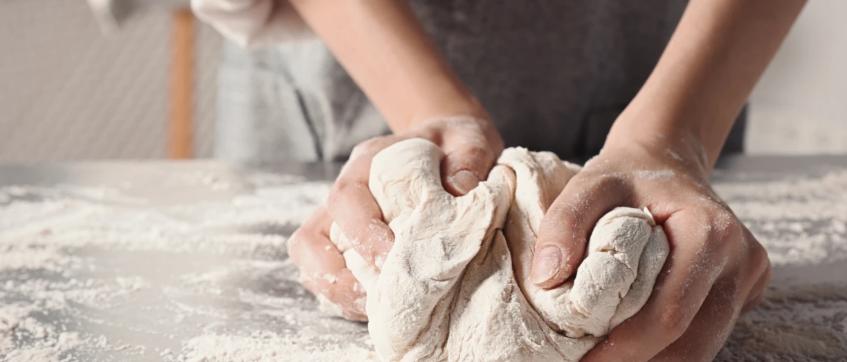 Closeup hands preparing dough 