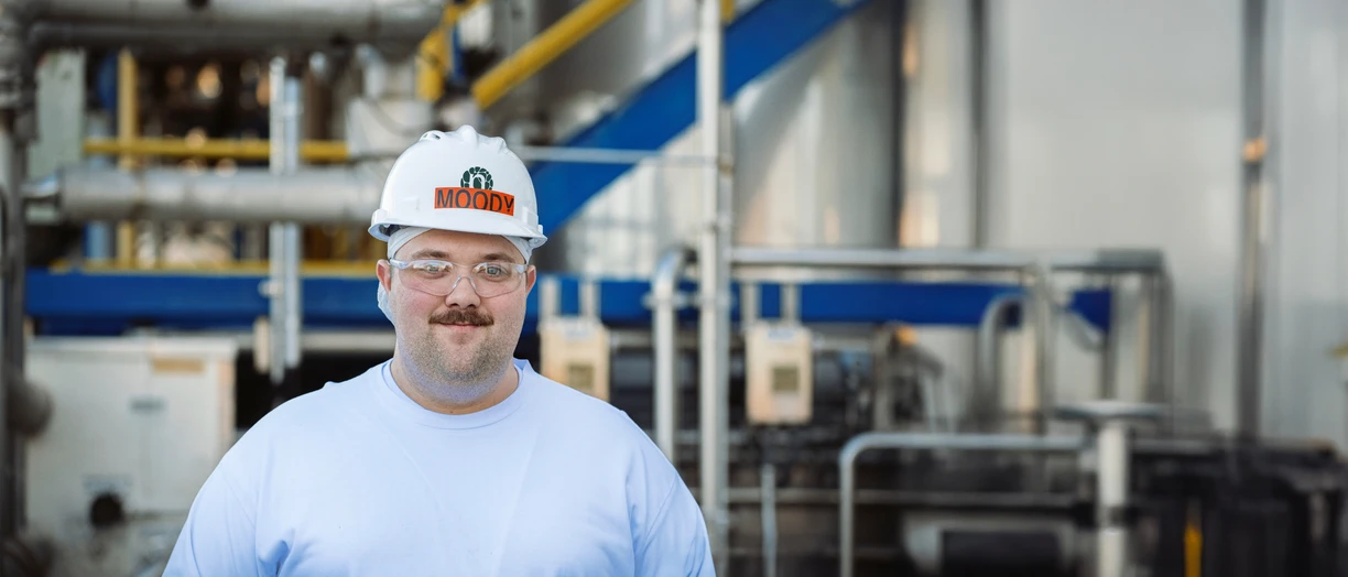 Guy in industry smiling to camera