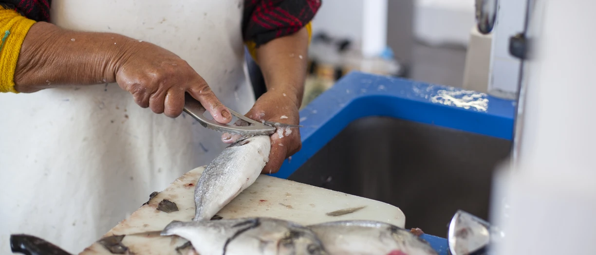A chef making fish ready for cooking