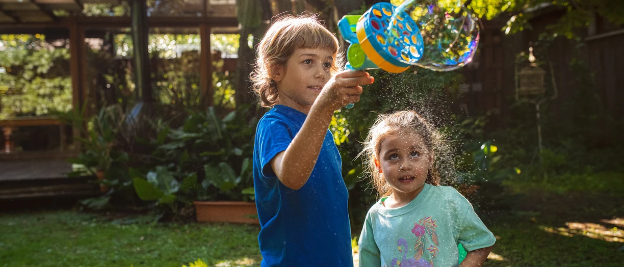 siblings playing bubbles