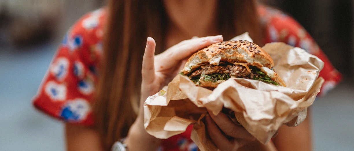 woman holding burger