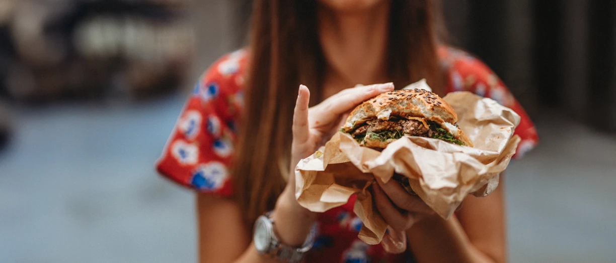 woman holding burger