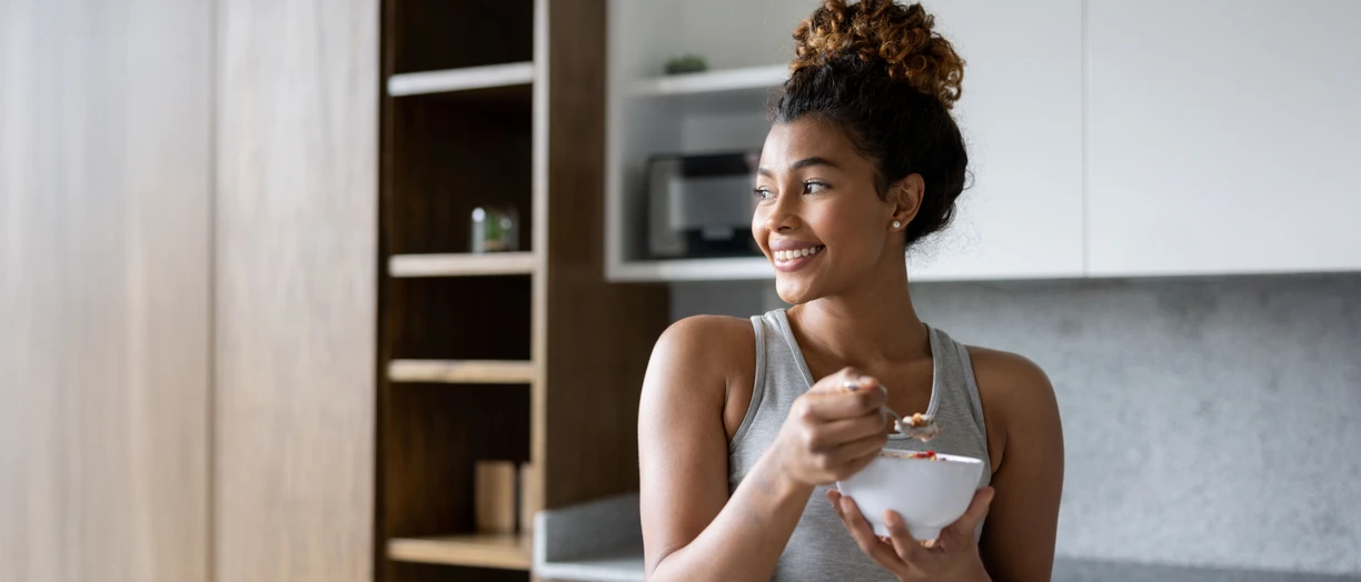 A young lady eating yogurt