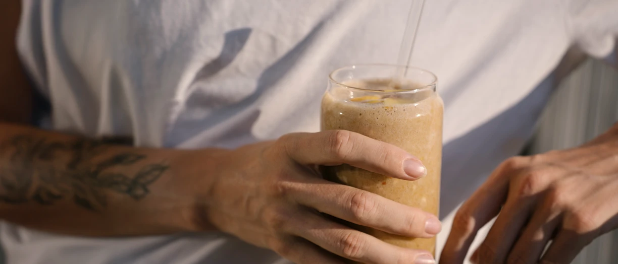 hand holding ice coffee drink