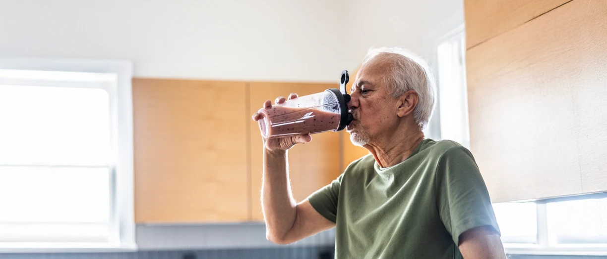 senior man drinking protein smoothie