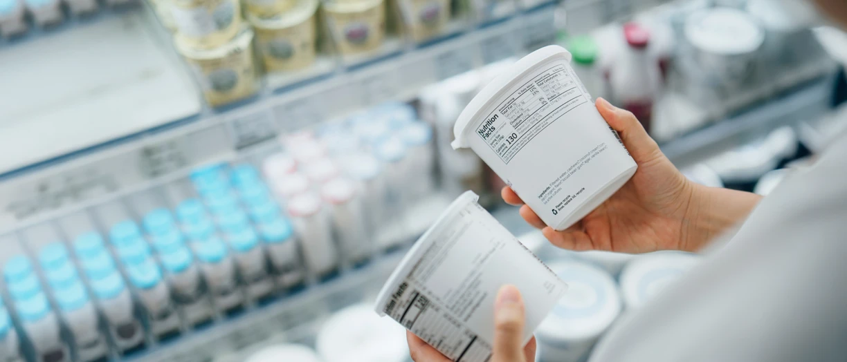 choosing yogurt in supermarket