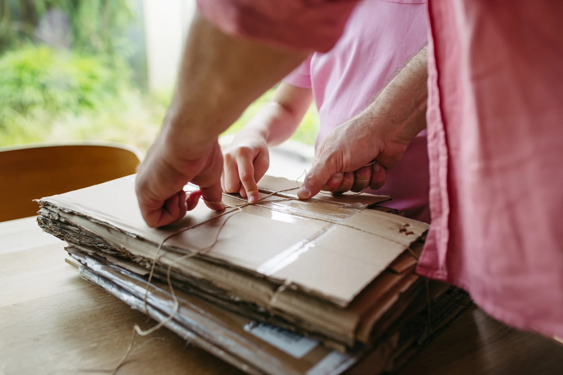 father and daughter preparing cardboard boxes for recycling
