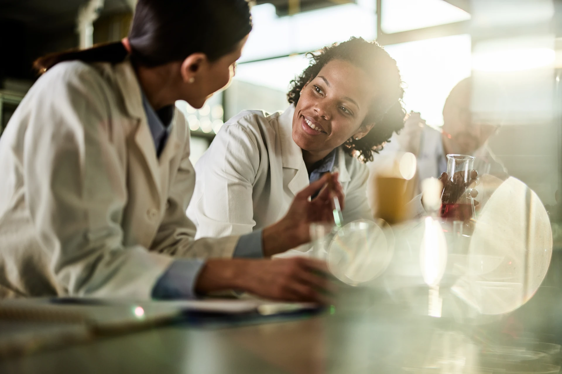 Scientists working and discussing in a lab