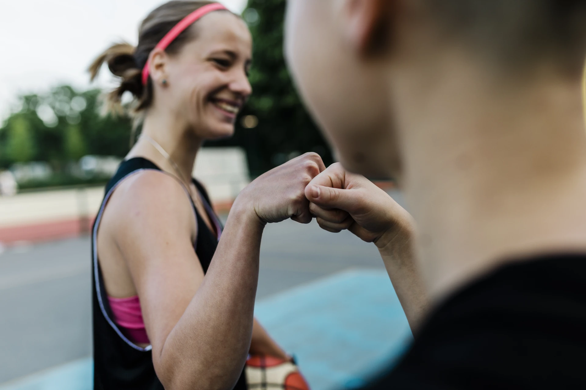 Women Basketball players greeting each other with a fist bump 