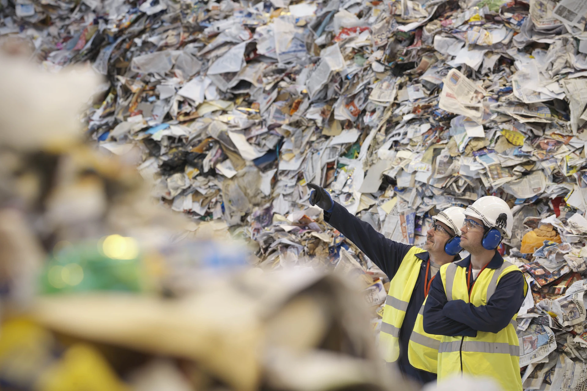 Workers discussing in a paper recycle station