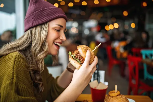 Woman enjoying plant-based meat burger