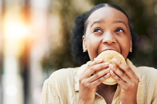 Woman_enjoying_a_tasty_burger_bun