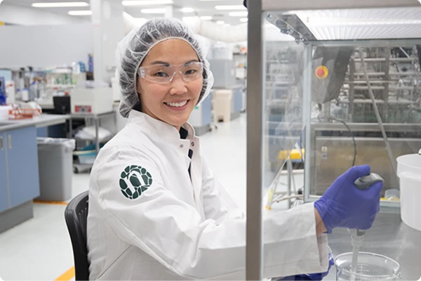 Lab girl smiling to camera in Novonesis coat