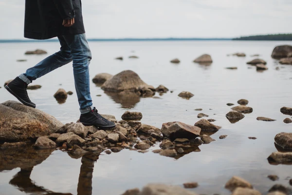 Man walking on rocks by the sea 