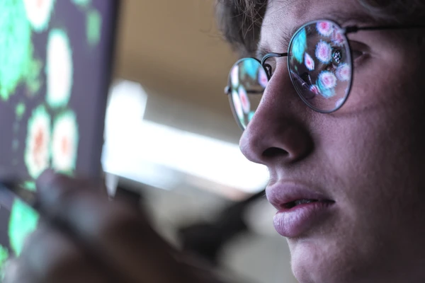 Scientist with glasses looking at data