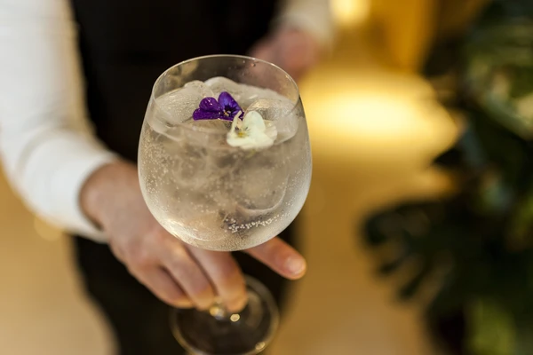 Waiter serving a gin and tonic