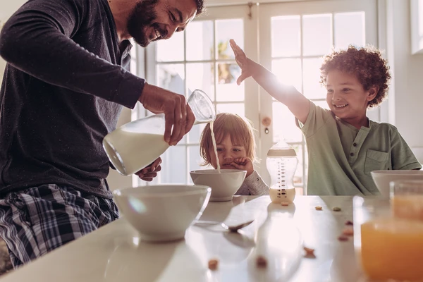 Father pouring milk