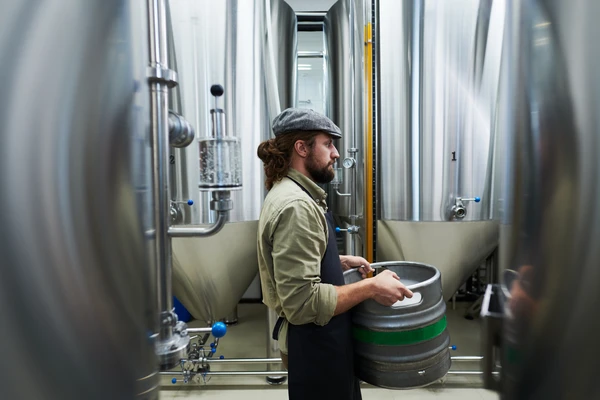A man carrying large beer fsutage