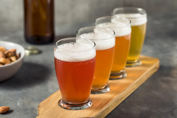 A row of different types of beer in a high glass