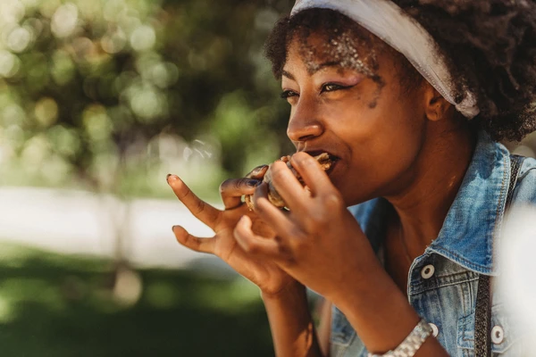 lady eating plant based burger 