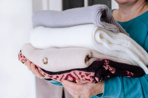 Stack of folded wool sweaters.