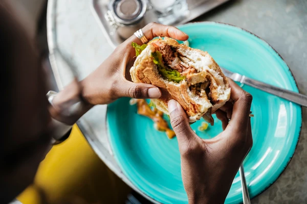 A-woman-eating-plant-based-burger