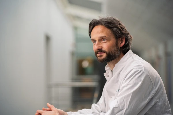 Scientist in a crisp white lab coat, exuding a calm and focused demeanor 